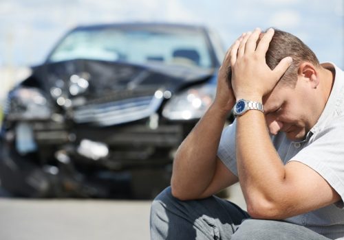 Adult upset driver man in front of automobile crash car collision accident in city road